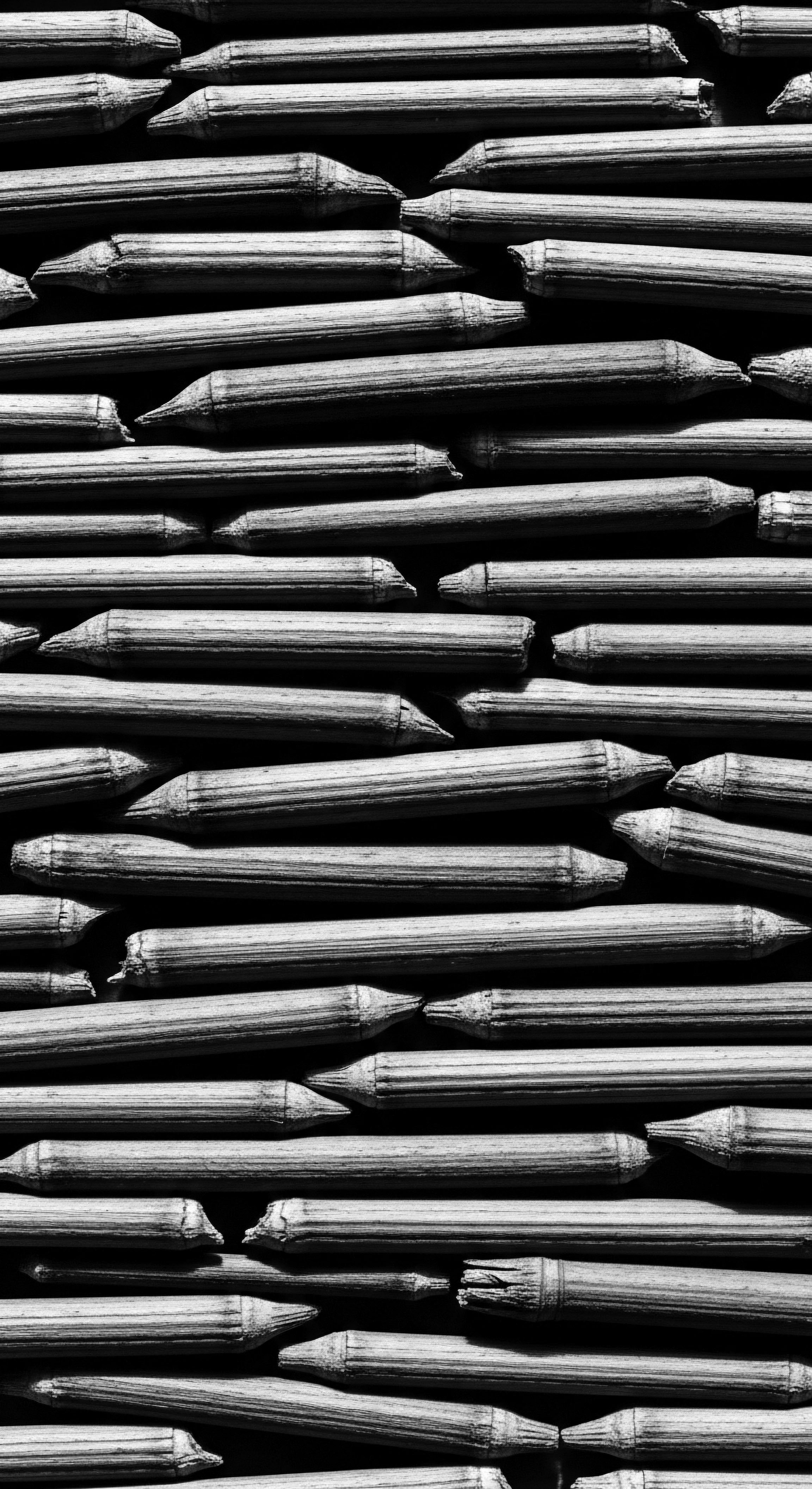 Abstract Bamboo Texture Demonstrating Natural Patterns of Growth and Interconnectivity The repetitive arrangement of bamboo stalks, accentuated by light and shadow, creates a visually captivating texture, resonating with the interwoven narrative of heritage. These stalks mirror the strength found in traditional hair care philosophies, reflecting holistic approaches to textured hair health and expressiveness.