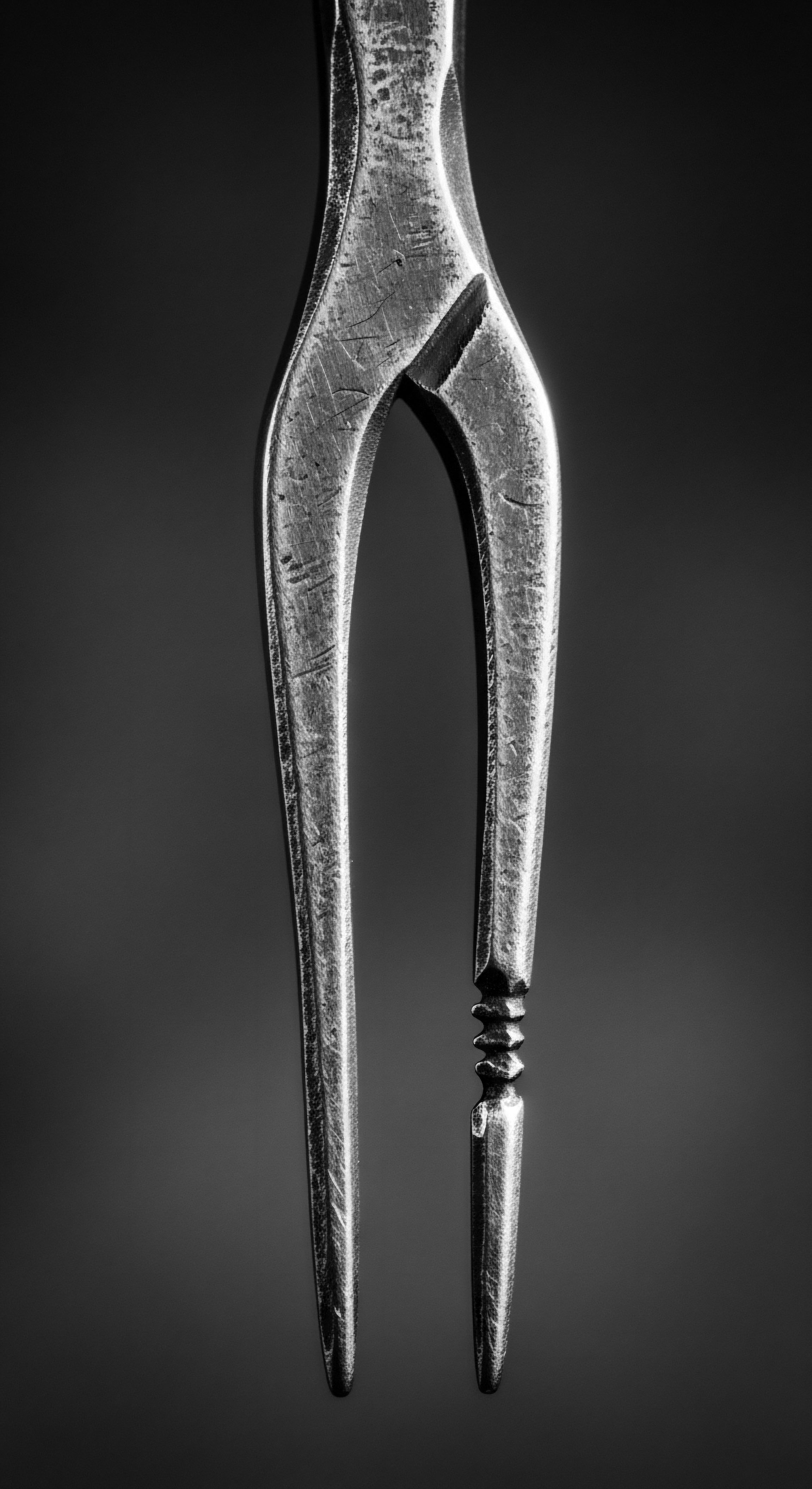 Antique Metal Tool Symbolizing Heritage and Ancestral Roots in Black Hair This timeless metal tool echoes practices from ancestral heritage where hair rituals held deep cultural meaning within Black communities symbolic of knowledge transferred from generations. Evokes the careful crafting and mindful intention applied to holistic afro hair care practices.