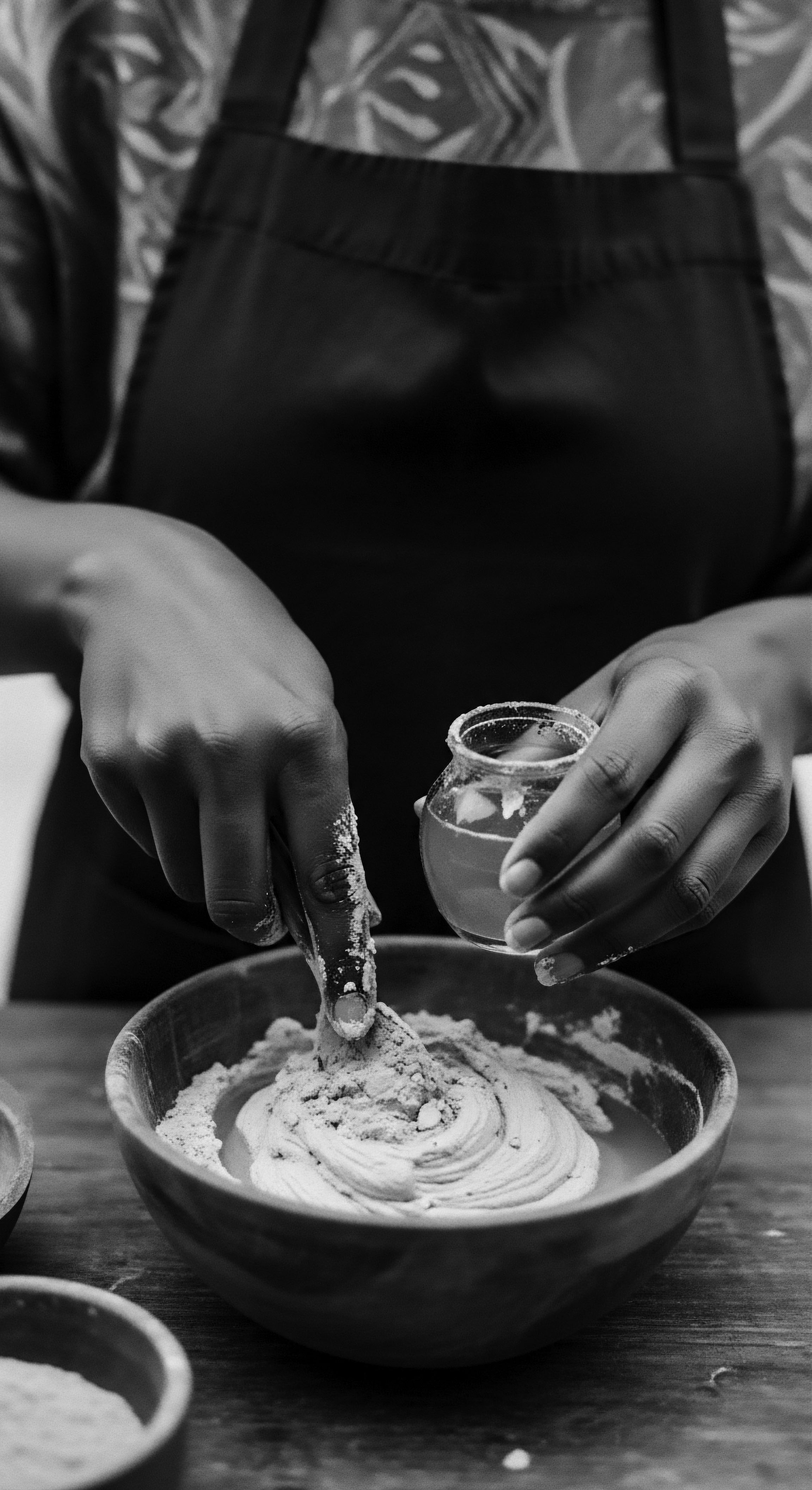 Artisan Hands Crafting Textured Hair Mask Black and White Aesthetic Hands meld ancient traditions with holistic wellness, meticulously crafting a nourishing hair mask. This act preserves heritage, celebrating rich coil textures through time-honored techniques and earth-sourced ingredients. It serves as a ritual honoring beauty.