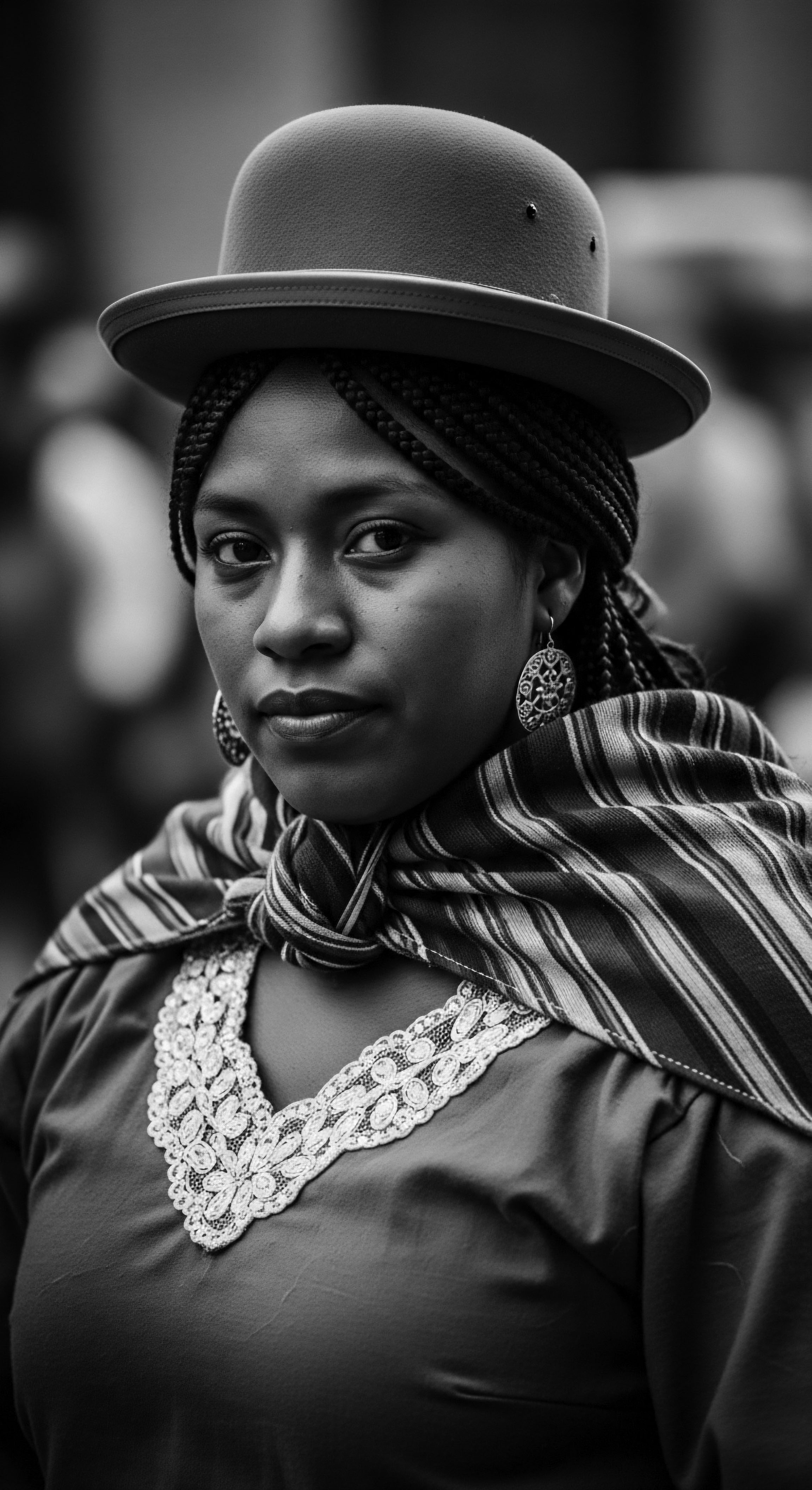 Bolivian Woman Wearing Traditional Aguayo Shawl and Hat Black and White Portrait This black and white portrait captures the serene dignity of a Bolivian woman, showcasing her traditional dress and expertly braided textured hair, a potent symbol of cultural identity and ancestral heritage. The aguayo shawl and bowler hat frame her expressive features, conveying depth and inner strength.