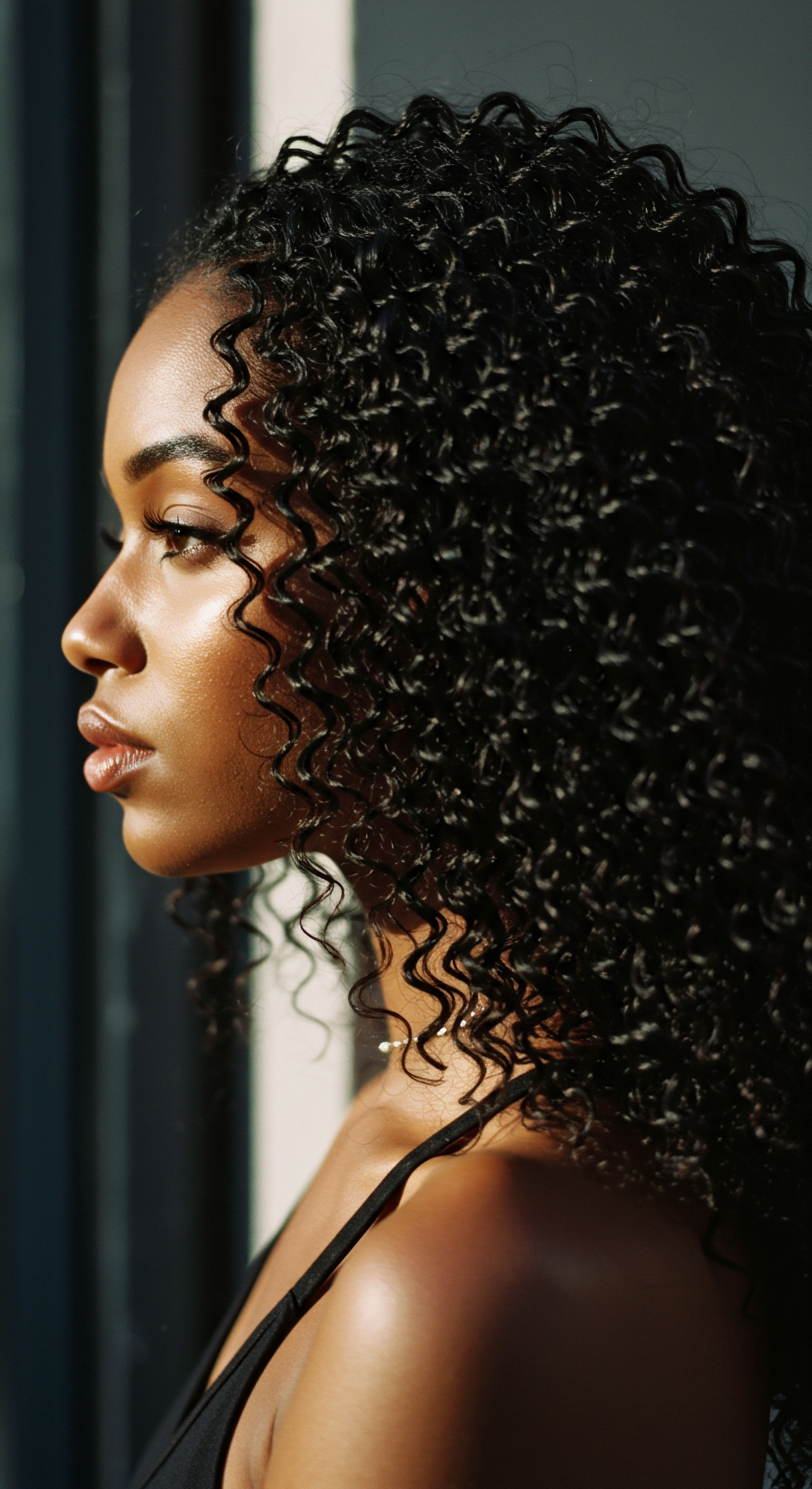 Celebrating Defined Black Textured Hair Patterns And Optimal Hydration Resilience This compelling profile celebrates vibrant Black textured hair. Exquisite high-shine and perfectly defined S-patterns reflect optimal hydration and resilience. Highlighting expert care for mixed-race hair, it beautifully honors heritage through natural styling and strong pattern retention.