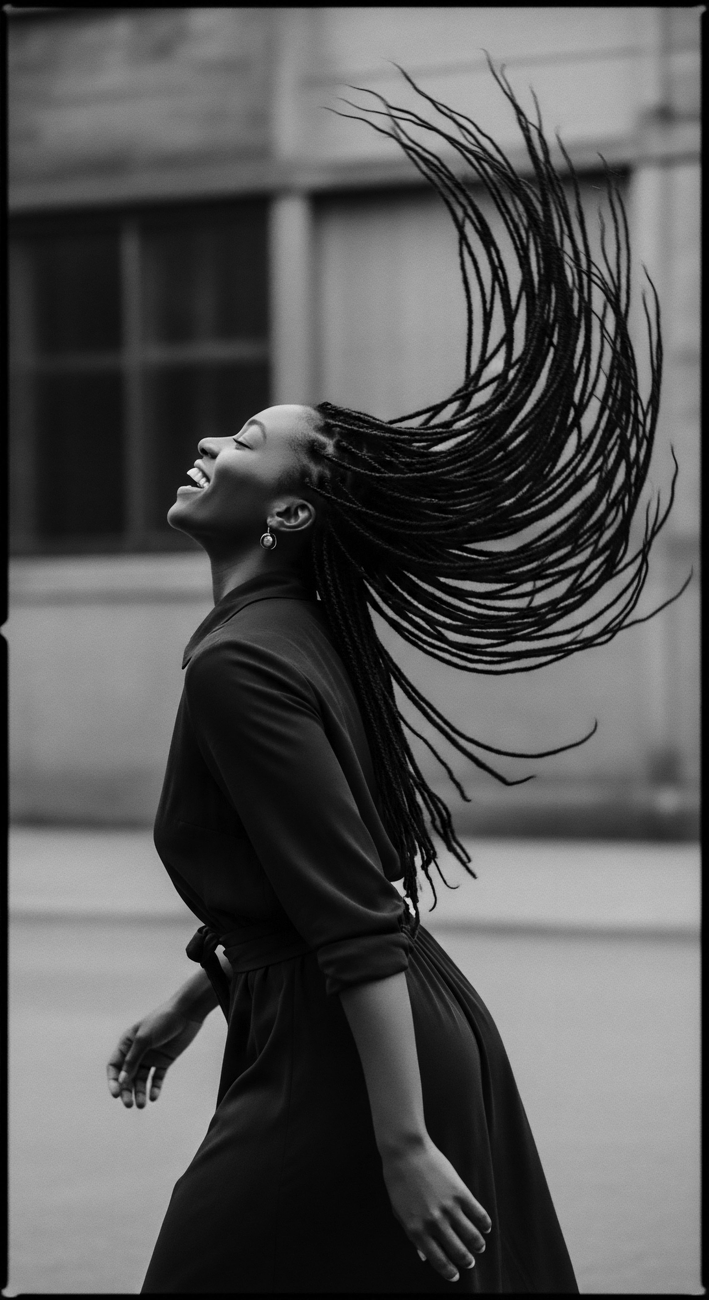 In a moment of uninhibited joy, the woman’s hairstyle becomes a vibrant extension of her spirit, the braided texture capturing a blend of heritage and self-expression, resonating with ancestral strength and contemporary beauty standards as a protective style that echoes holistic hair care and cultural pride.