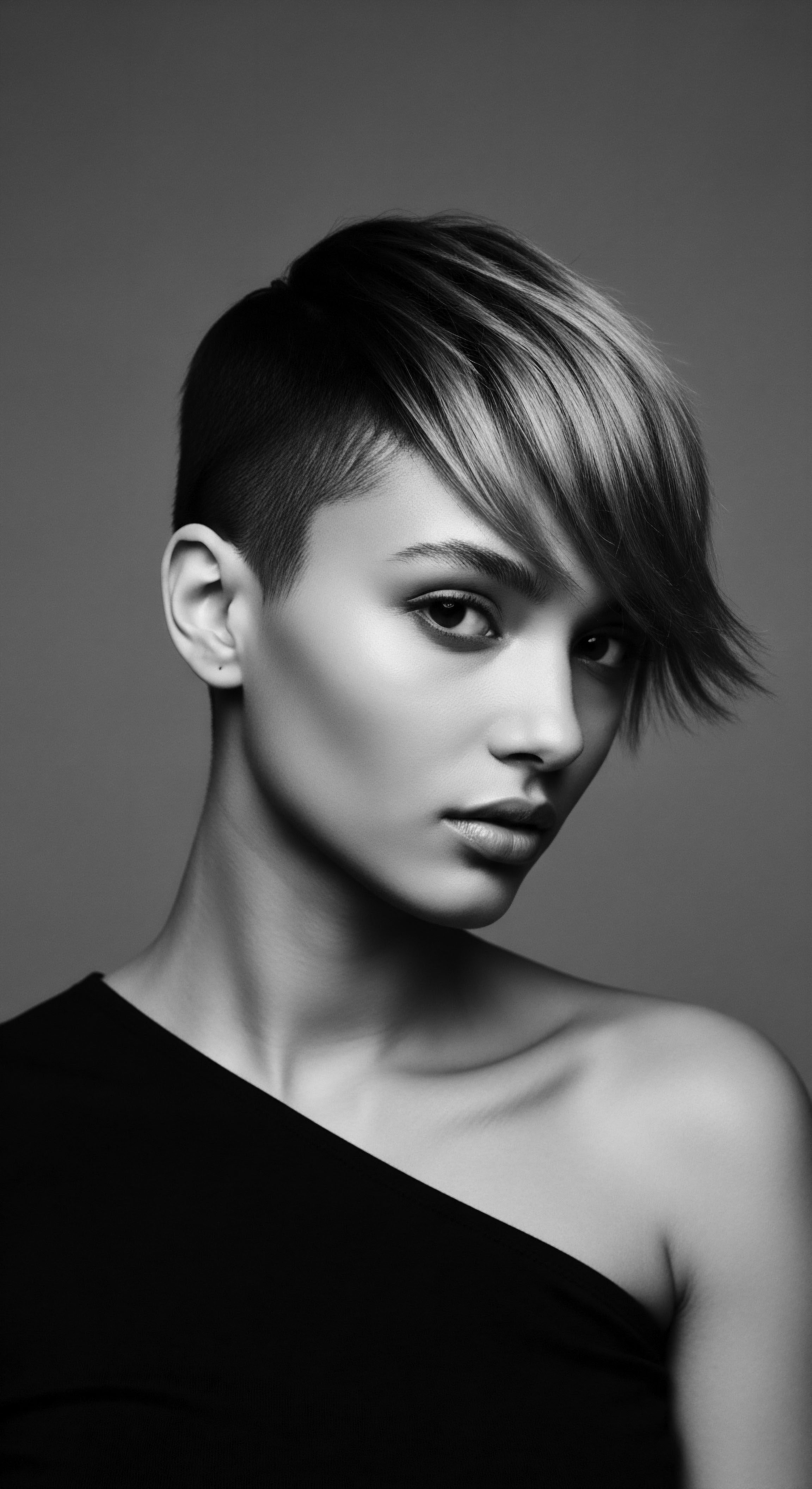 Edgy Undercut Hairstyle Chic Black and White Portrait Dramatic Lighting Embracing self-expression, the subject's strong undercut and focused gaze reflect contemporary beauty, echoing themes of personal freedom within textured hair narratives. This image blends modern styling with timeless elegance, embodying holistic hair care practices, enhanced by dramatic lighting.