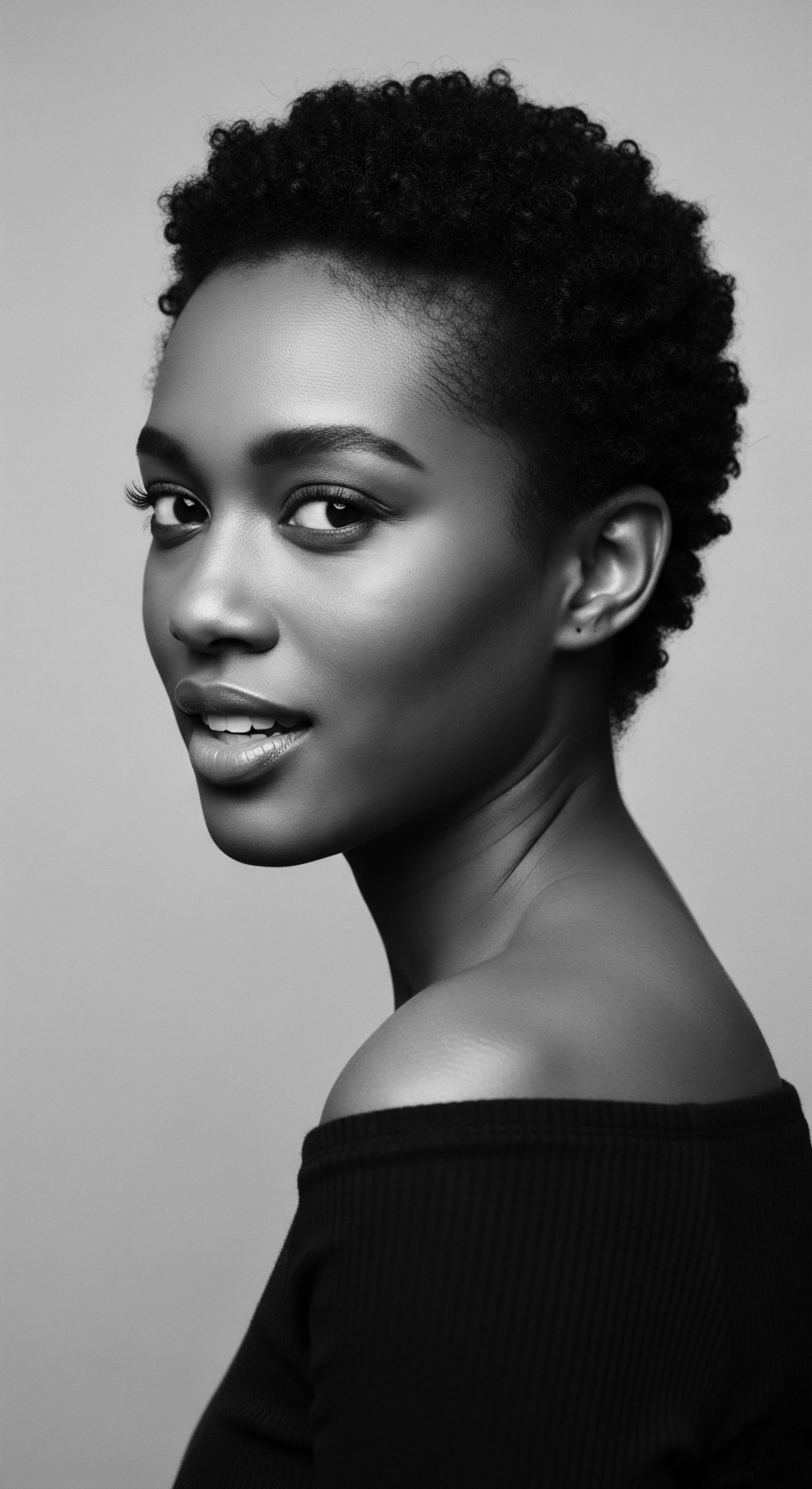 Elegant Black Woman with Tapered Afro Showcasing Natural Textured Hair Beauty This striking portrait captures the essence of natural beauty, celebrating the strength and resilience embodied in tightly coiled afro hair. The image evokes a sense of empowerment and pride, connecting textured hair to ancestral heritage and a modern expression of self-acceptance, styled with minimalist modern afro aesthetic.