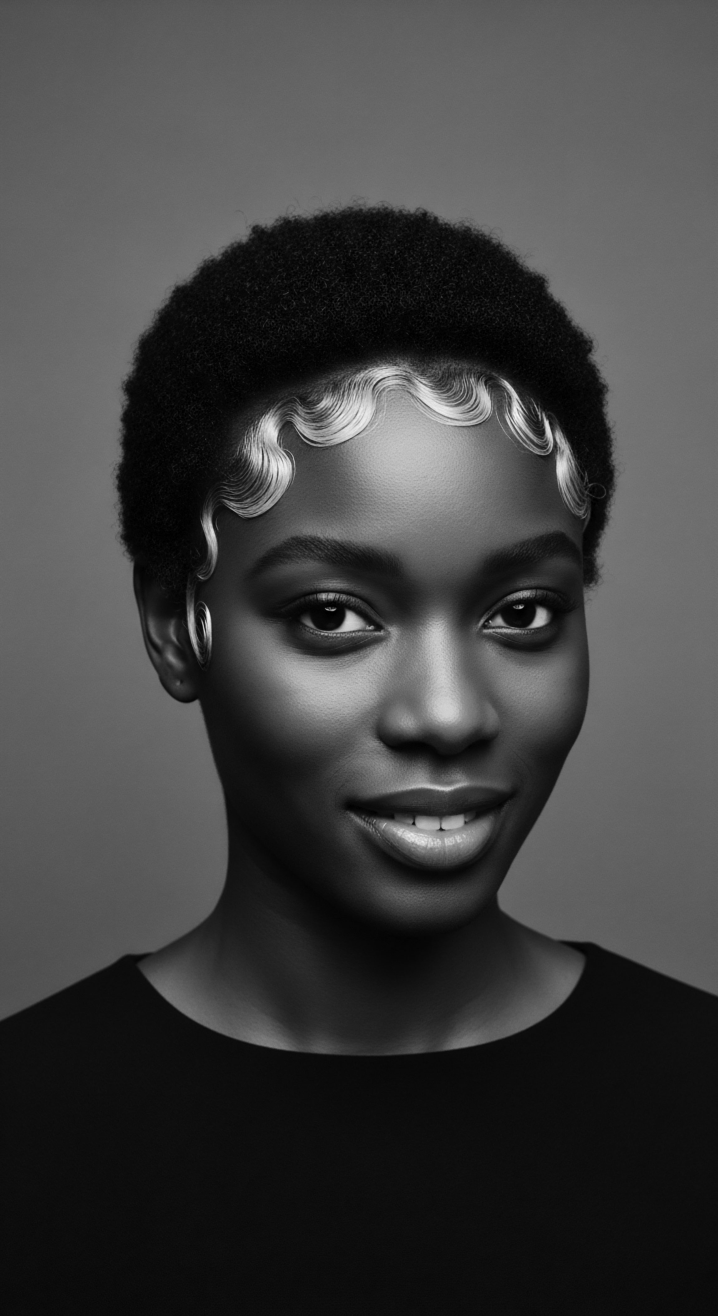 Elegant Close Up Portrait of a Woman with Frosted Waves Hairstyle This monochromatic study of beauty highlights ancestral heritage through innovative styling. The focus on short afro hair with frosted waves evokes the power of self-expression, a commitment to holistic hair care, and underscores the mixed-race hair narrative celebrated for its unique textured formation.