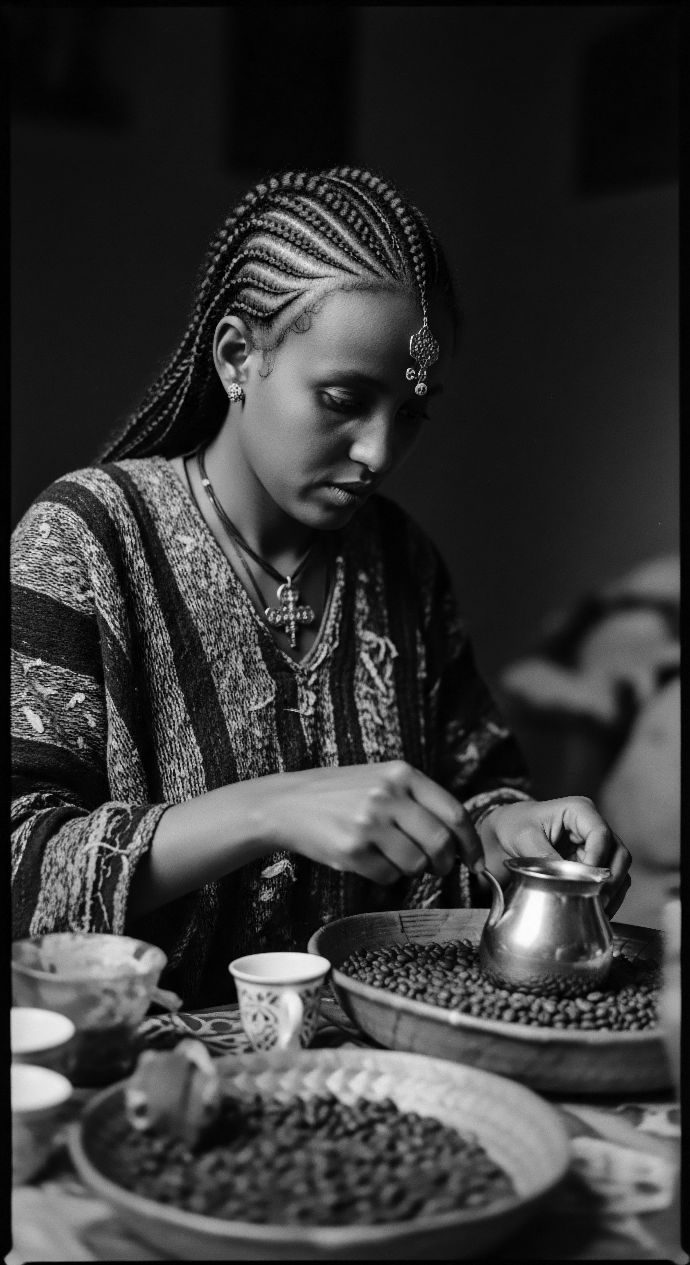 Ethiopian Woman Preparing Coffee Traditional Braids and Heritage Jewelry Bathed in soft light, the woman's braided hair is carefully styled, while she prepares coffee beans, a timeless ritual connecting her to Ethiopian traditions and ancestral heritage. Her thoughtful actions and traditional attire echo a deep connection to her culture.