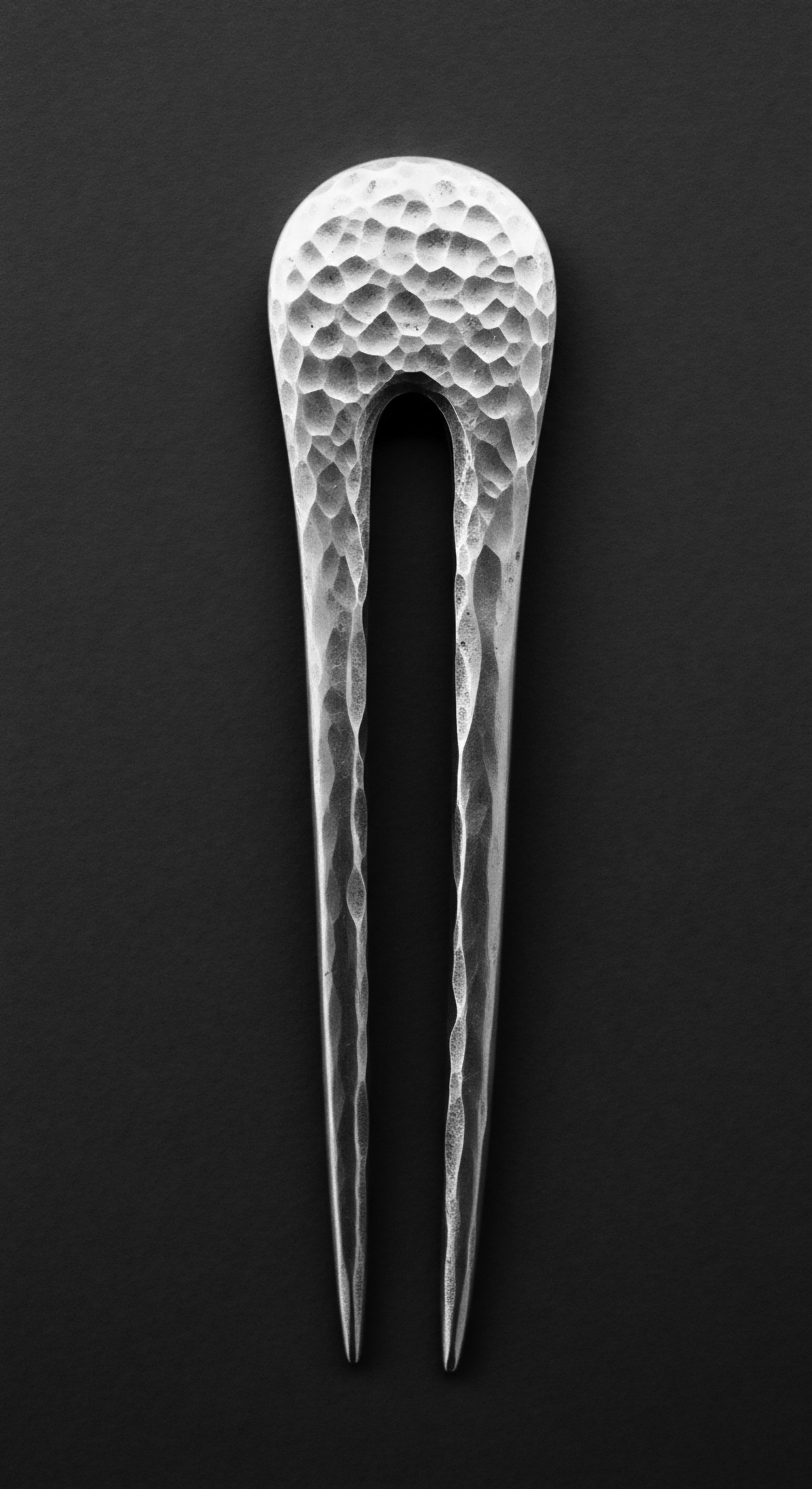 Hammered Metal Hair Fork for Textured Hair Ancient Heritage Artifact Style This silver-toned hammered hair fork stands as a symbol of enduring hairstyling practices, reflecting the rich heritage of securing and adorning textured formations. Integrating this durable design blends time-honored traditions with contemporary use, embodying holistic wellness and confident, expressive self-care.