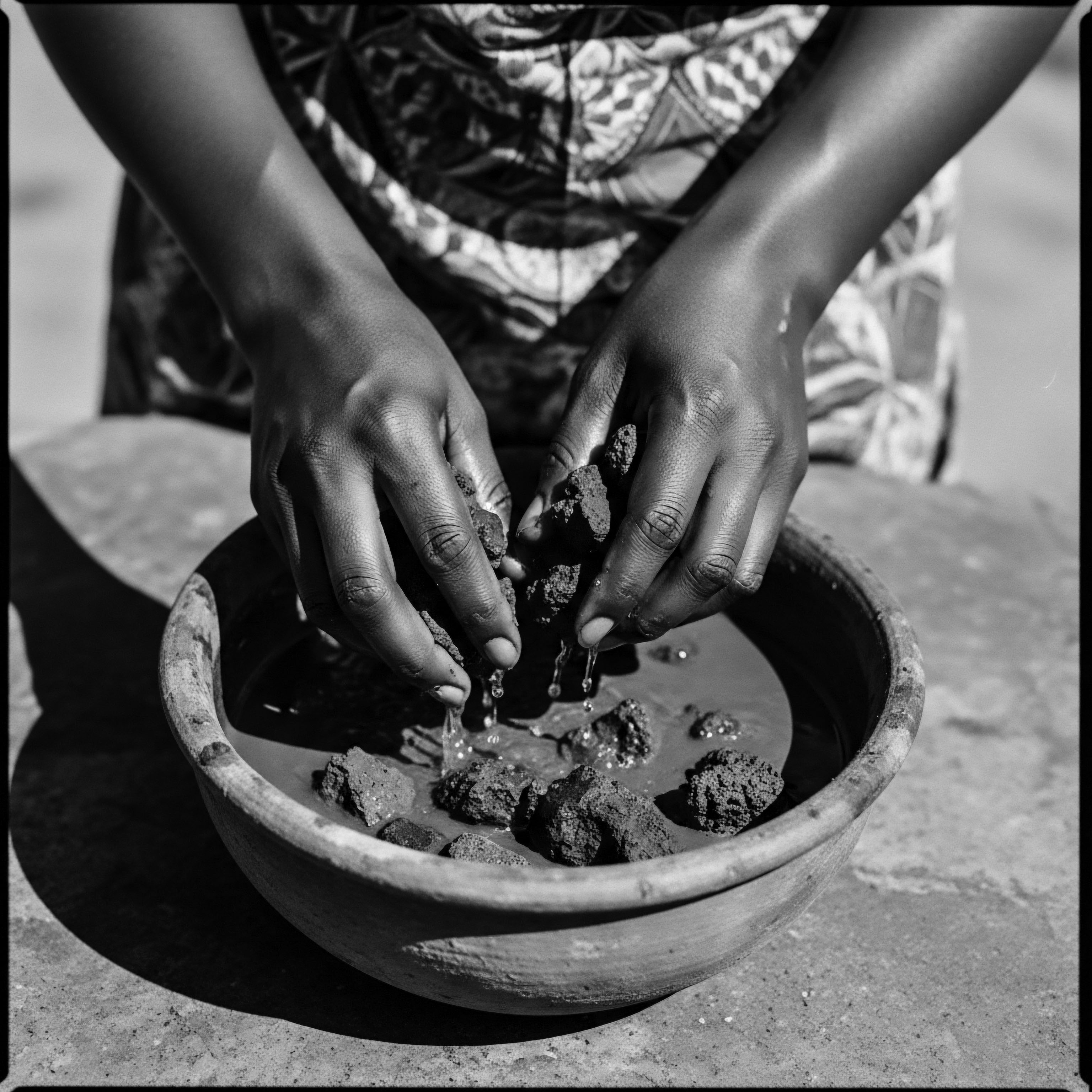Hands Preparing Natural Clay Mask for Afro Textured Hair Holistic Care Hands gently melding earth elements in a clay bowl reveal a deep cultural ritual for preparing a natural clay treatment, offering an ancestral perspective on textured hair’s unique needs, bridging heritage with contemporary practices for holistic maintenance and optimal scalp health.