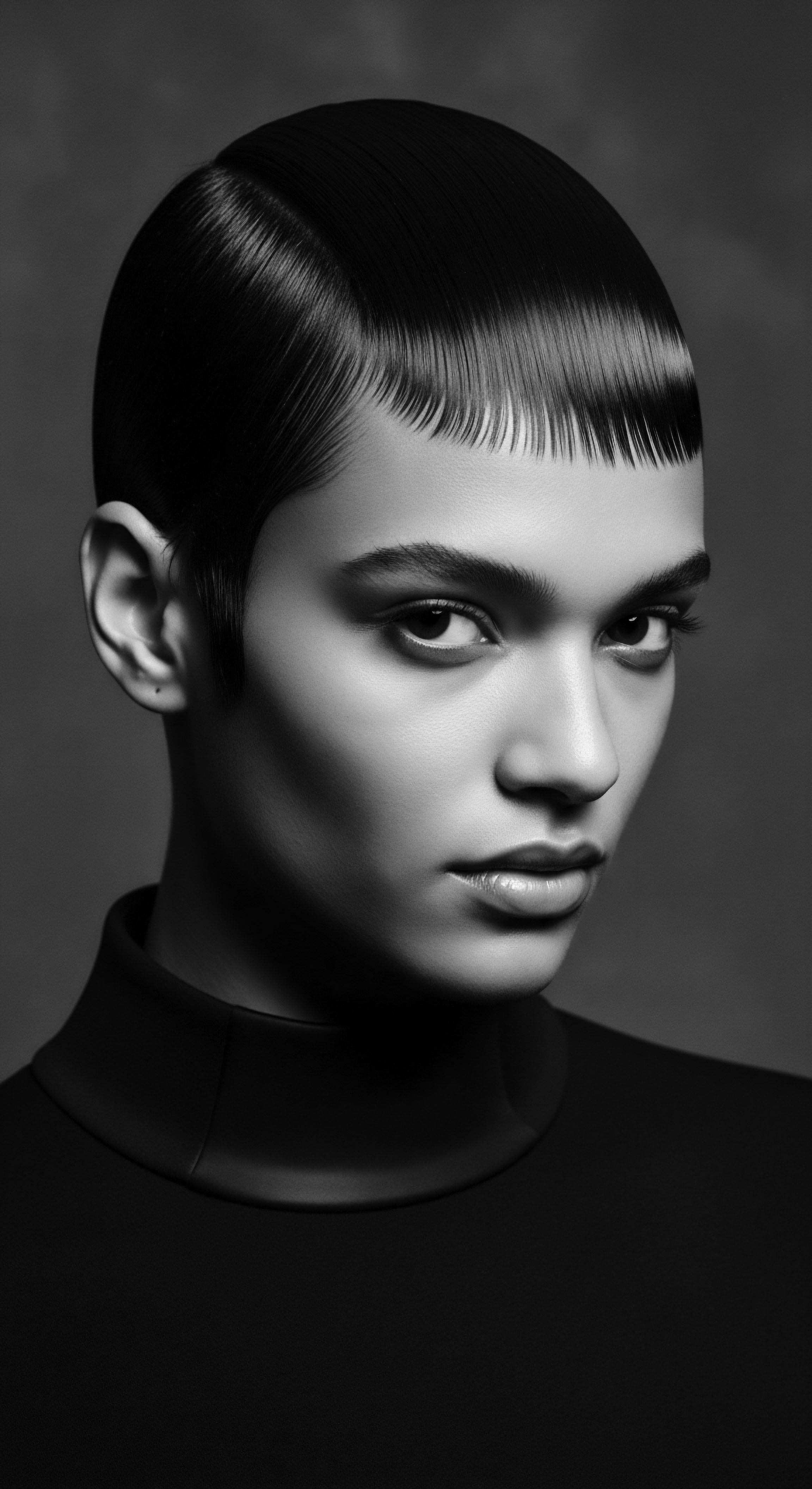 Monochrome Portrait of Woman with Elegant Textured Hair and Intense Gaze This evocative image captures a modern woman with heritage texture, celebrated in a contemporary context, reflecting strength and sophistication. Her polished hair is a tribute to both expressive styling and mindful holistic hair care, symbolizing the essence of beauty through texture and intentionality, a blend of heritage and personal narrative.