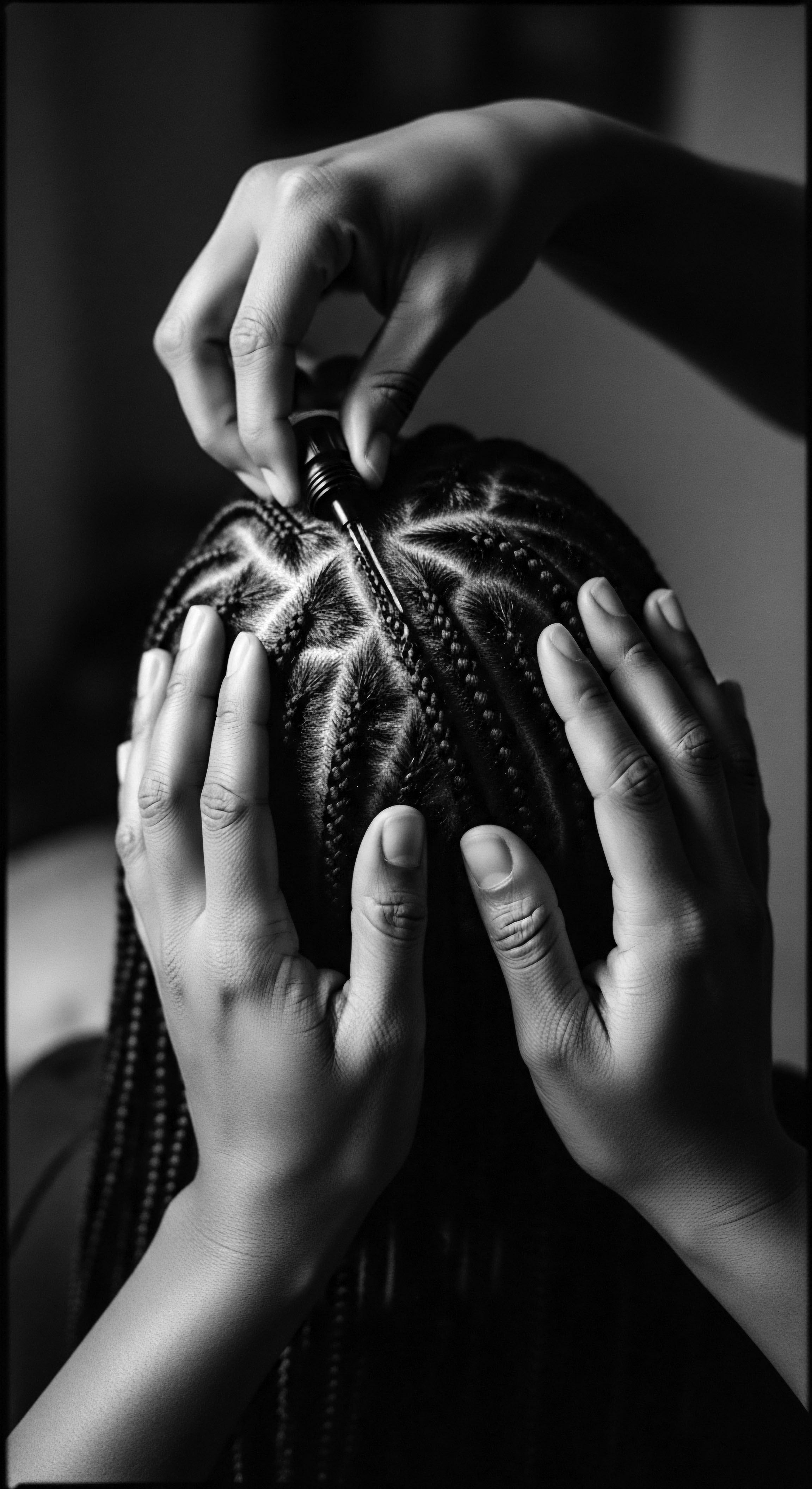 Precision Styling and Braiding: Textured Hair Artistry and Cultural Expression This image embodies the artistry of hair styling, reflecting a legacy of Black hair traditions and expressive styling. The precise parting and braiding signify a dedication to both personal expression and the ancestral heritage woven into the care of textured hair.