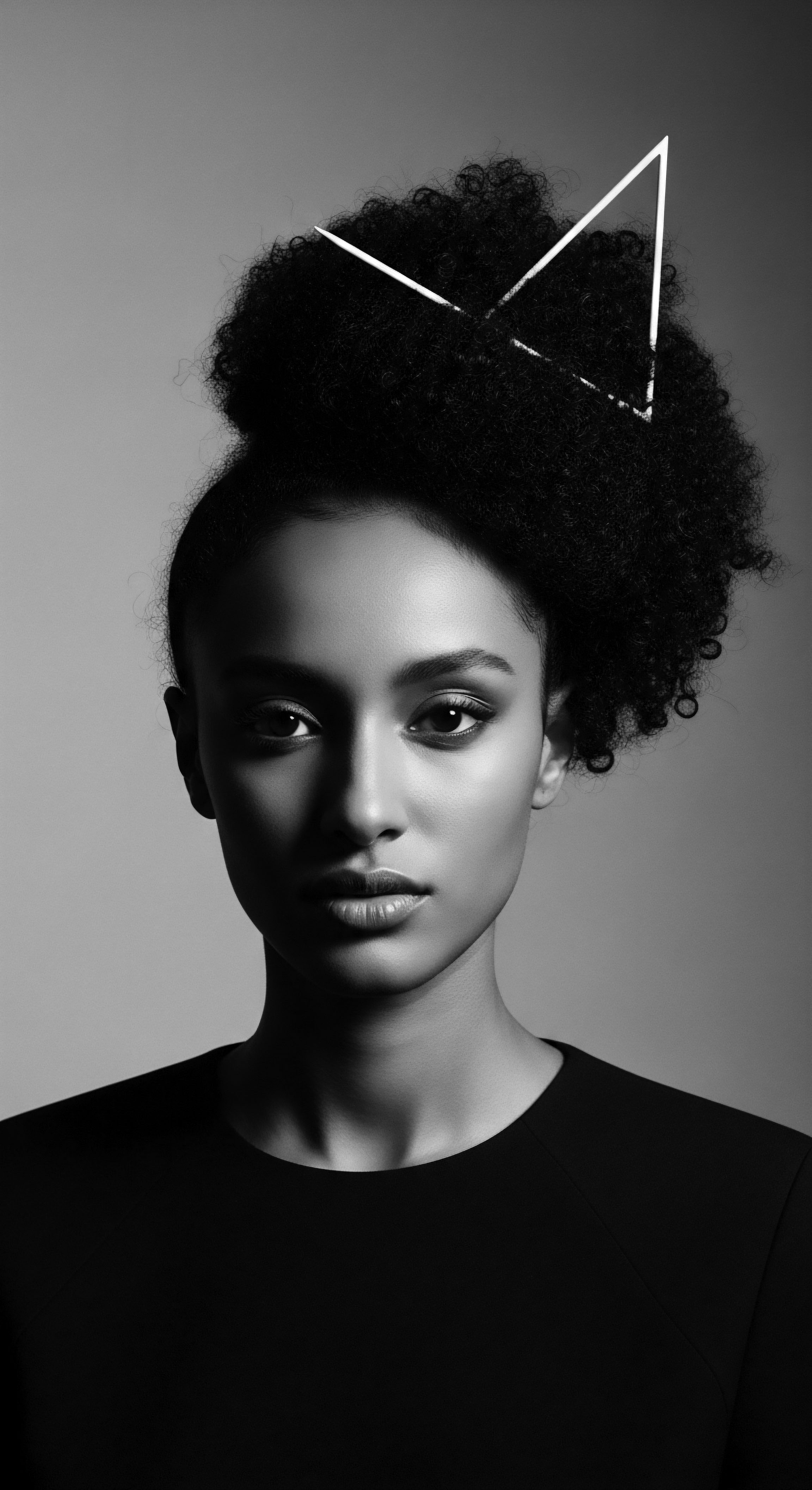 Striking Portrait Black and White Woman Textured Afro Hair Geometric Accent This evocative monochromatic portrayal celebrates textured hair, highlighting its natural formations accentuated by geometric design elements, in a minimalist style. The image invites viewers to contemplate heritage, identity, and inherent beauty expressed through confident and authentic Black aesthetics.