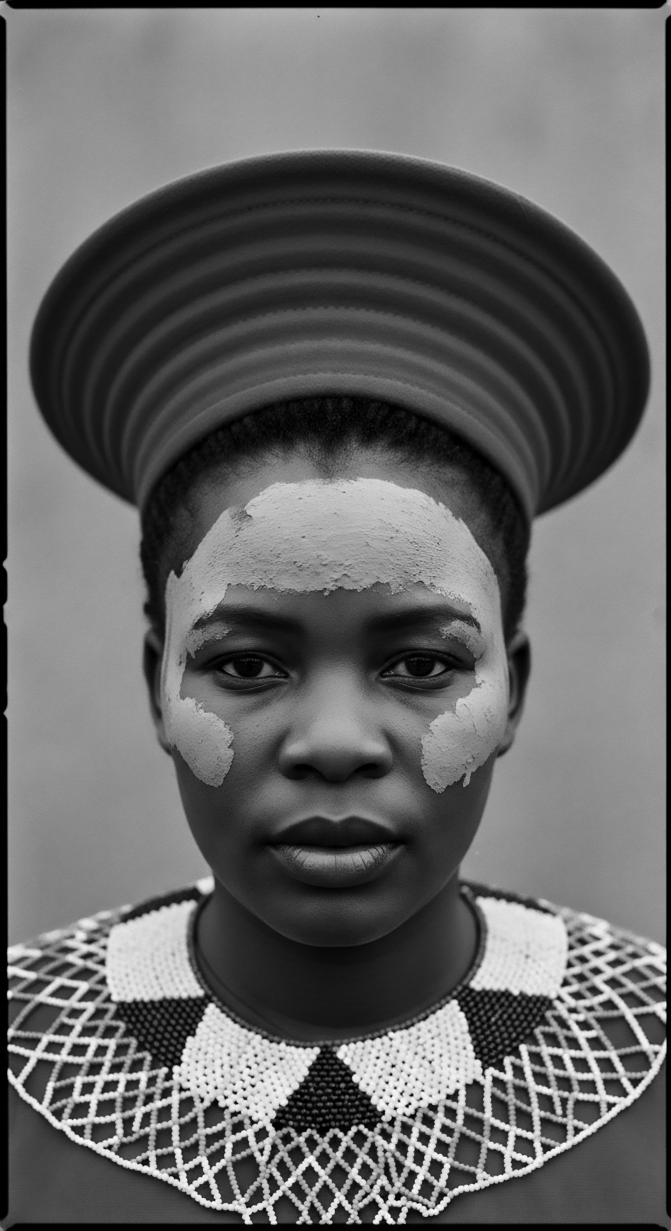 Striking Portrait of Zulu Woman Adorned in Traditional Attire and Makeup This evocative portrait captures the dignity and grace of a Zulu woman, whose traditional attire and artful makeup reflect a rich cultural heritage. The photograph celebrates the beauty of textured hair, ancestry, and traditions passed through generations, symbolizing resilience and cultural pride.