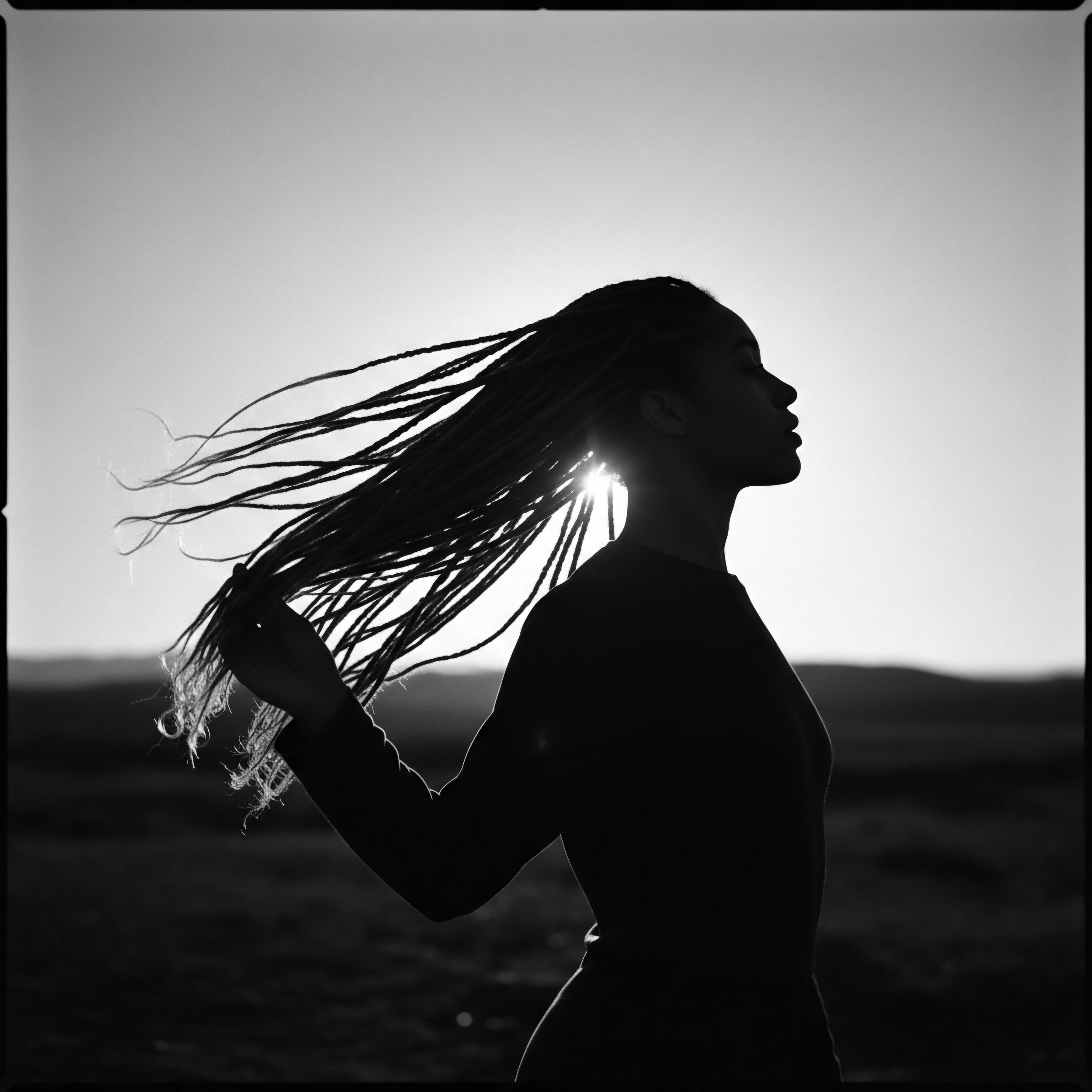 Woman Silhouette Against Sunlight Showcasing Braided Textured Hair In Expressive Styling The portrait encapsulates the dance between light and shadow, celebrating the unique texture of braided hair. It evokes a sense of ancestral connection, holistic hair care rituals passed down through generations, and the powerful expression of cultural identity inherent in traditional Black hair styling.